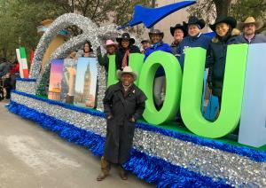 Houston Mayor Sylvester Turner poses with Houston Airports staff in front of the Houston Airports float