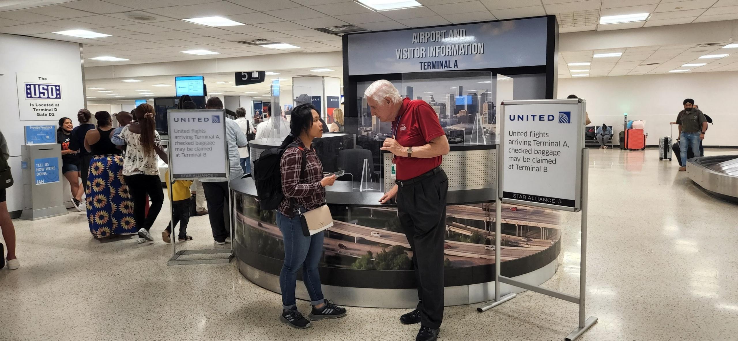 Paul Barker helps a woman who had just arrived at Bush Airport