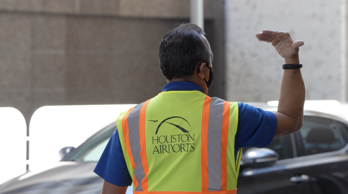 Man directing traffic for Houston Airports