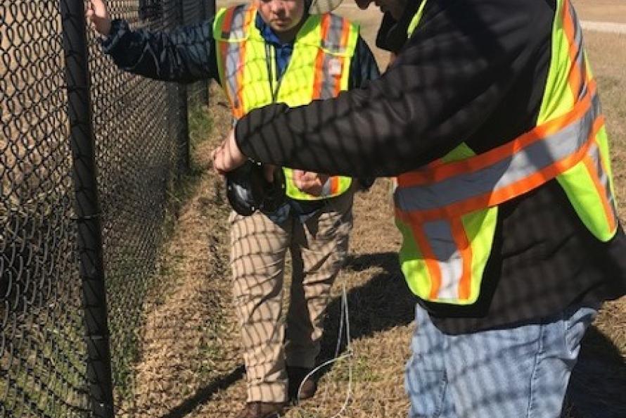 USDA biologist trains an IAH employee in the use of snares 