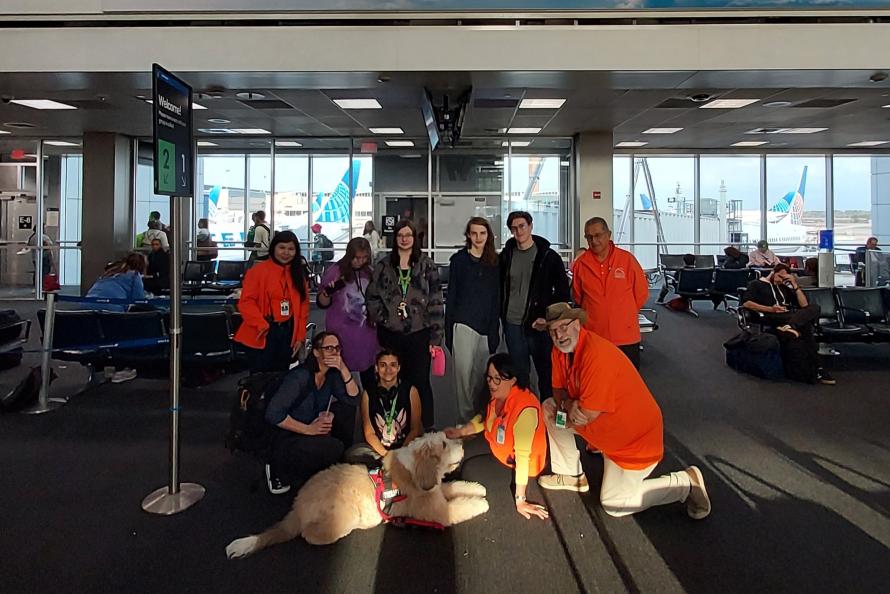 Snickers a therapy dog visits with passengers at IAH