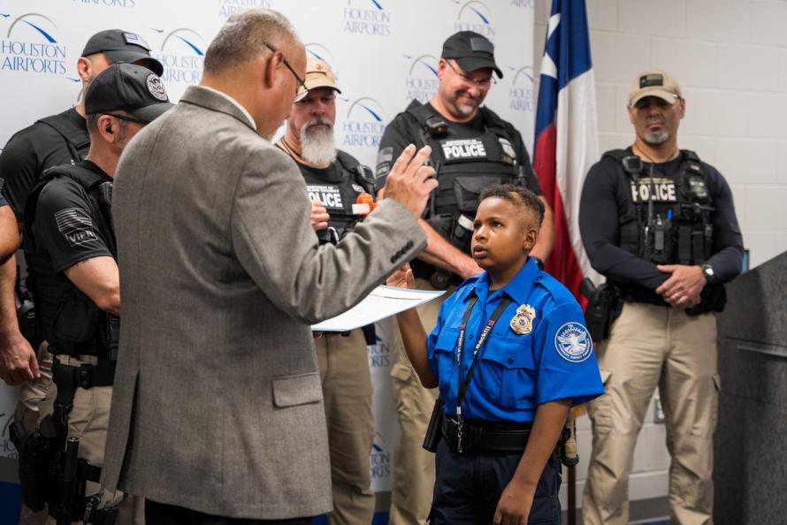 DJ Daniel is sworn-in as an honorary Federal Air Marshal while surrounded by members of the TSA/FAMS Visible Intermodal Prevention and Response Team