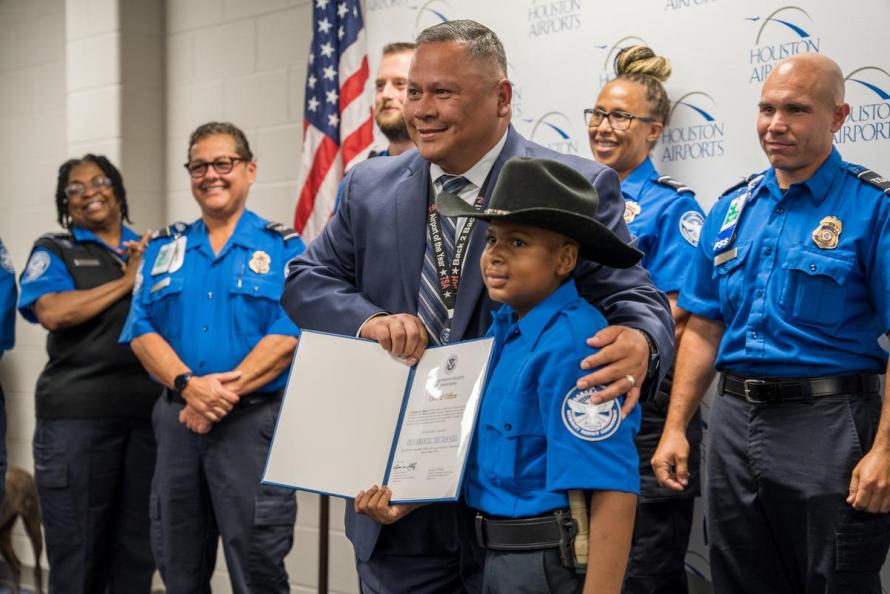 Houston Federal Security Director Juan Sanchez congratulates 10-year-old Devarjaye “DJ” Daniel for becoming an honorary TSA officer at George Bush Intercontinental Airport