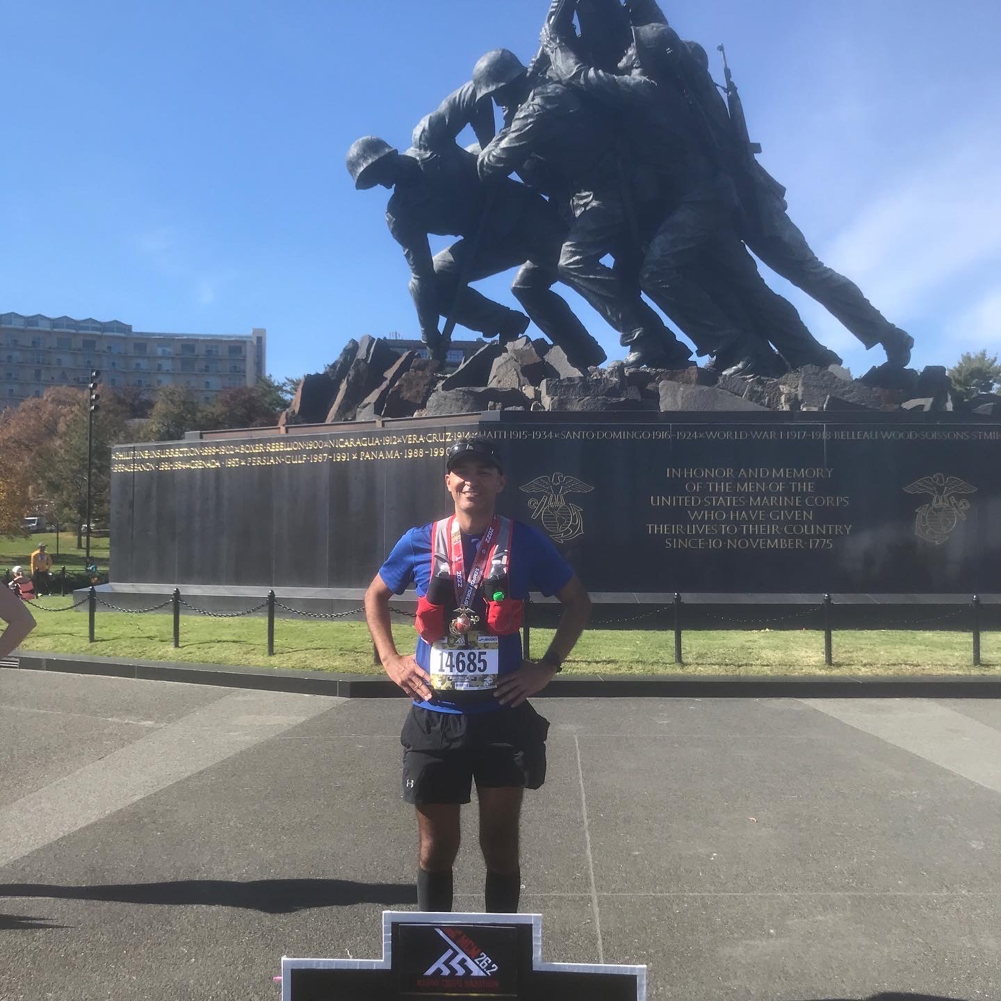 Miguel Ramirez poses for a photo in front of the Iwo Jima War Memorial 
