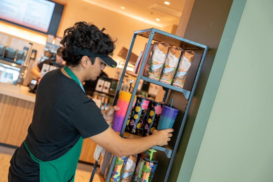 Starbucks employee stocking the shelves