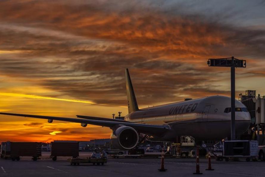 View of a United 777, parked on C North Gate C7 with a Hawaii destination. 