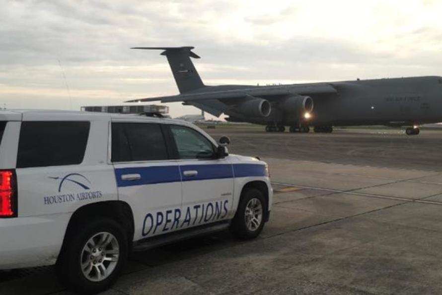 Photo of Houston Airports Operations vehicle parked near a U.S. Air Force C-17 transport aircraft