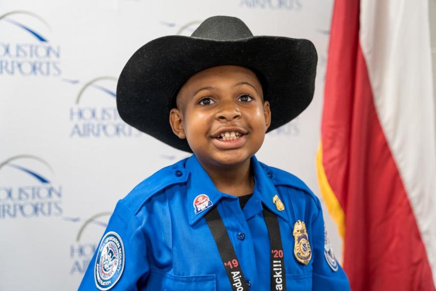 Dj Daniel smiles for a photo after being sworn-in as an honorary TSA officer