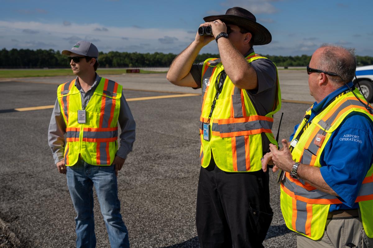 IAH staff use binoculars to look for wildlife at the airport 